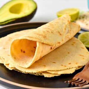 Cassava Flour Tortillas rolled on a plate.