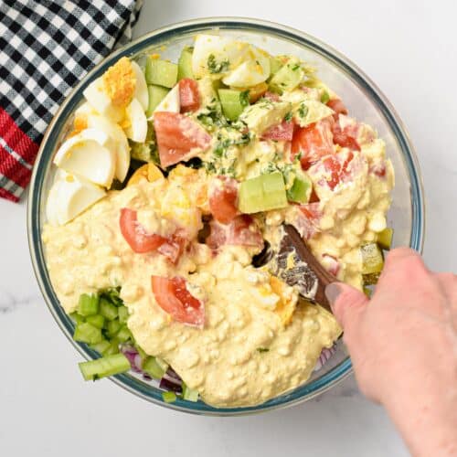 Combining the Cottage Cheese Salad with its dressing.