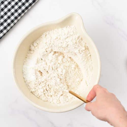 Sifting flour in a large bowl.