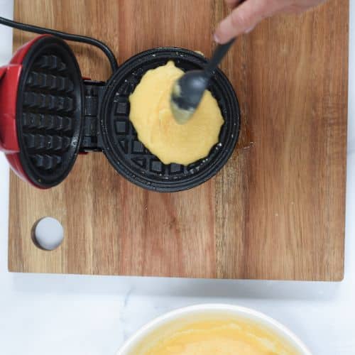 Spreading Coconut Flour Waffle batter on waffle iron.