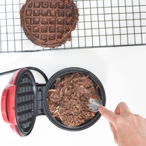 Pressing Keto Chocolate Chaffles batter in a waffle iron.