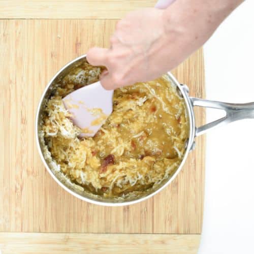 Mixing Keto German Chocolate Cake frosting ingredients in a pan.