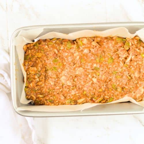 Pressed Keto Granola Bar batter in a loaf pan.