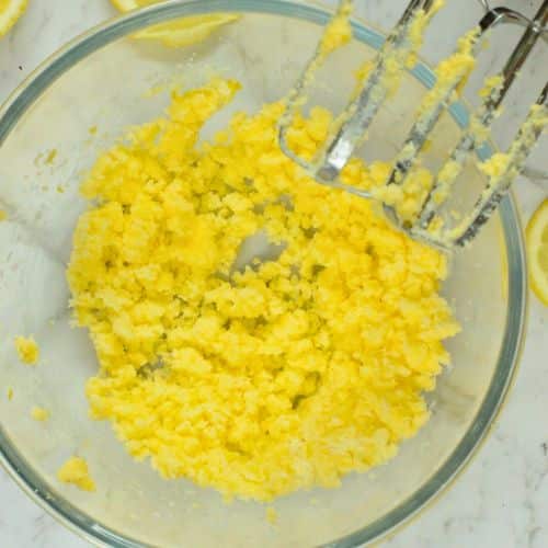 Mixed butter and powdered sweetener in a mixing bowl.