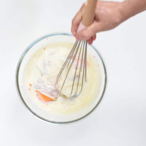 Mixing egg bake ingredients in a mixing bowl.