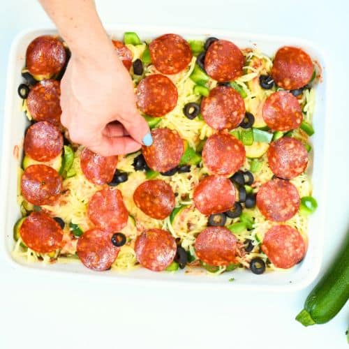 Adding pepperoni on the Zucchini Pizza Casserole